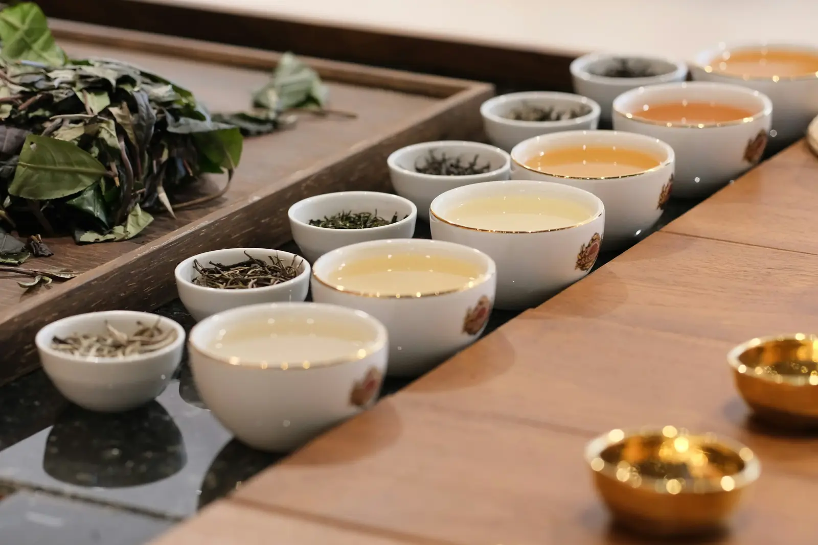 Tea taster cupping a row of teas